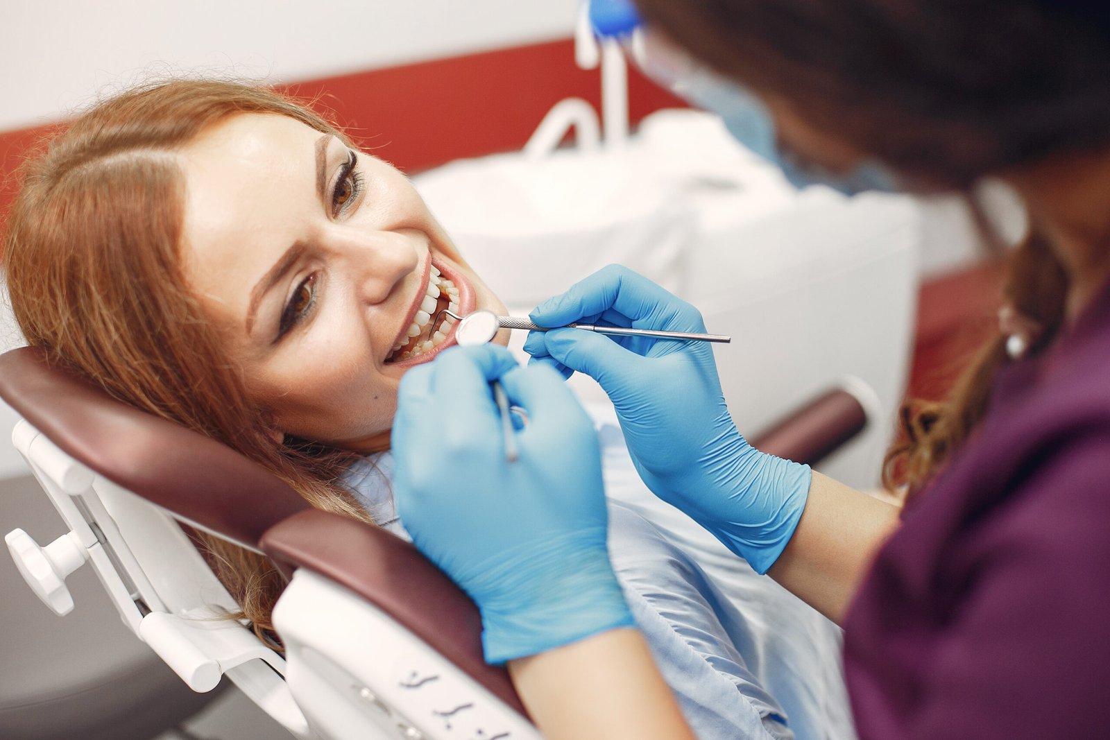 Beautiful lady in the dentist's office. Woman in a purple uniform