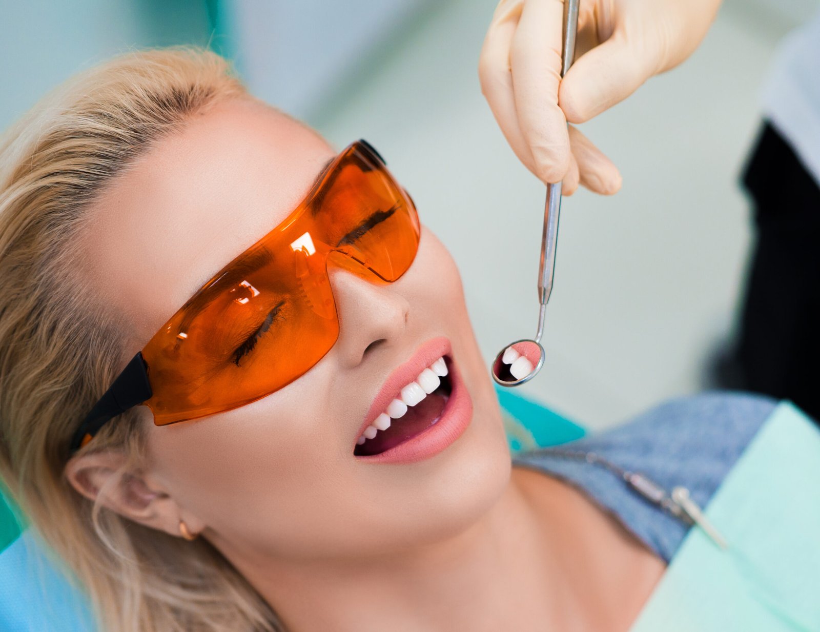 Close up photo of a woman visiting to the dentist. Teeth whitening concept